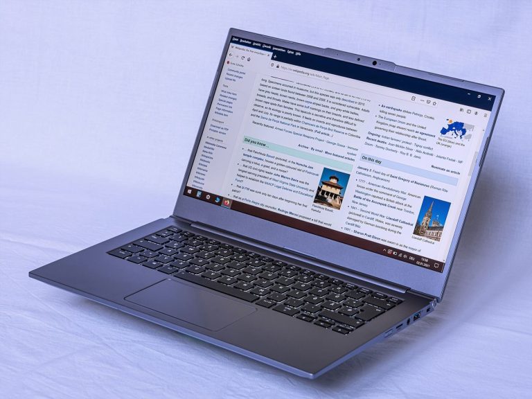 A tablet and laptop sit side by side on a tidy study desk with notebooks.